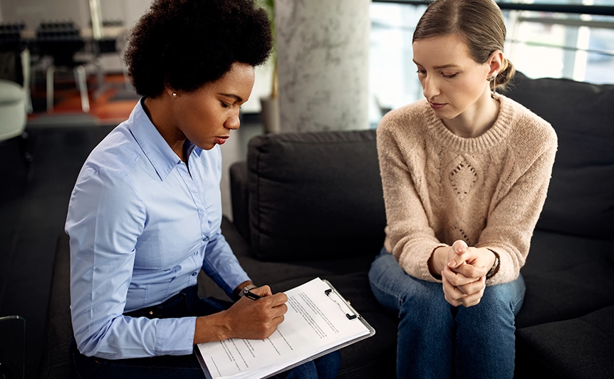 Therapist Taking Notes During a Marriage and Family Counseling Session