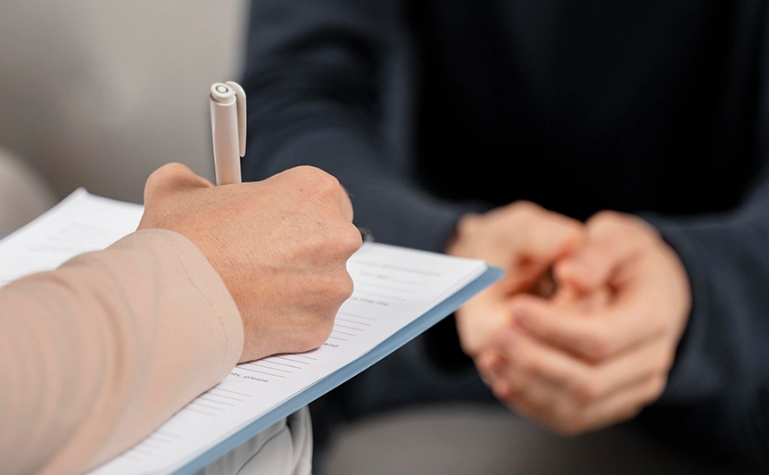Counselor Writing Notes During a Counseling Session