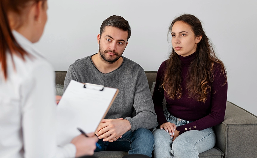 Couple Sitting on Sofa During Marriage and Family Counseling Session